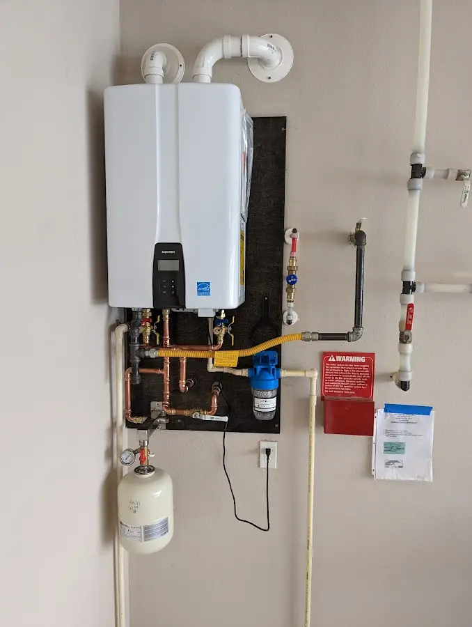 Professional plumber installing copper piping in a Norfolk home